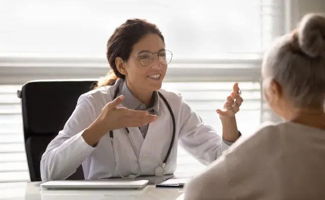 Nurse Practitioner Discussing Treatment Options with Adult Patient